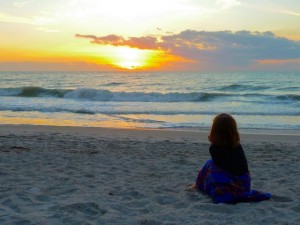 little girl watching sunset
