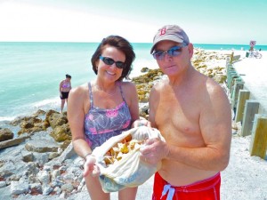 Shellers with bag of seashells