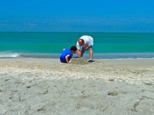 boy father with sand bucket boy father with sand bucket