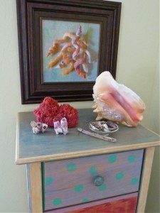 Display of seashells with painting Display of seashells with painting