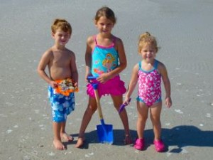 kids on beach with seashells